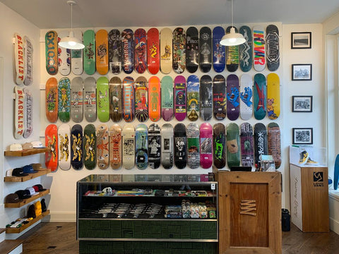 Wall display of skateboard decks at Blacklist