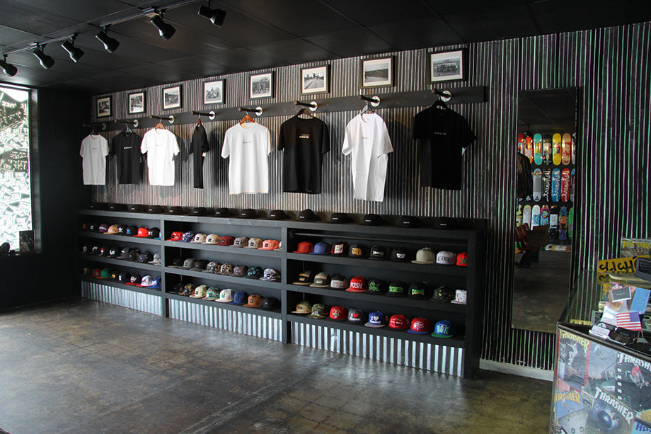 Blacklist branded t-shirts and hats on display