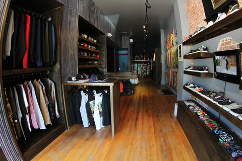 Wood-shelved apparel and footwear displays inside an early Blacklist shop