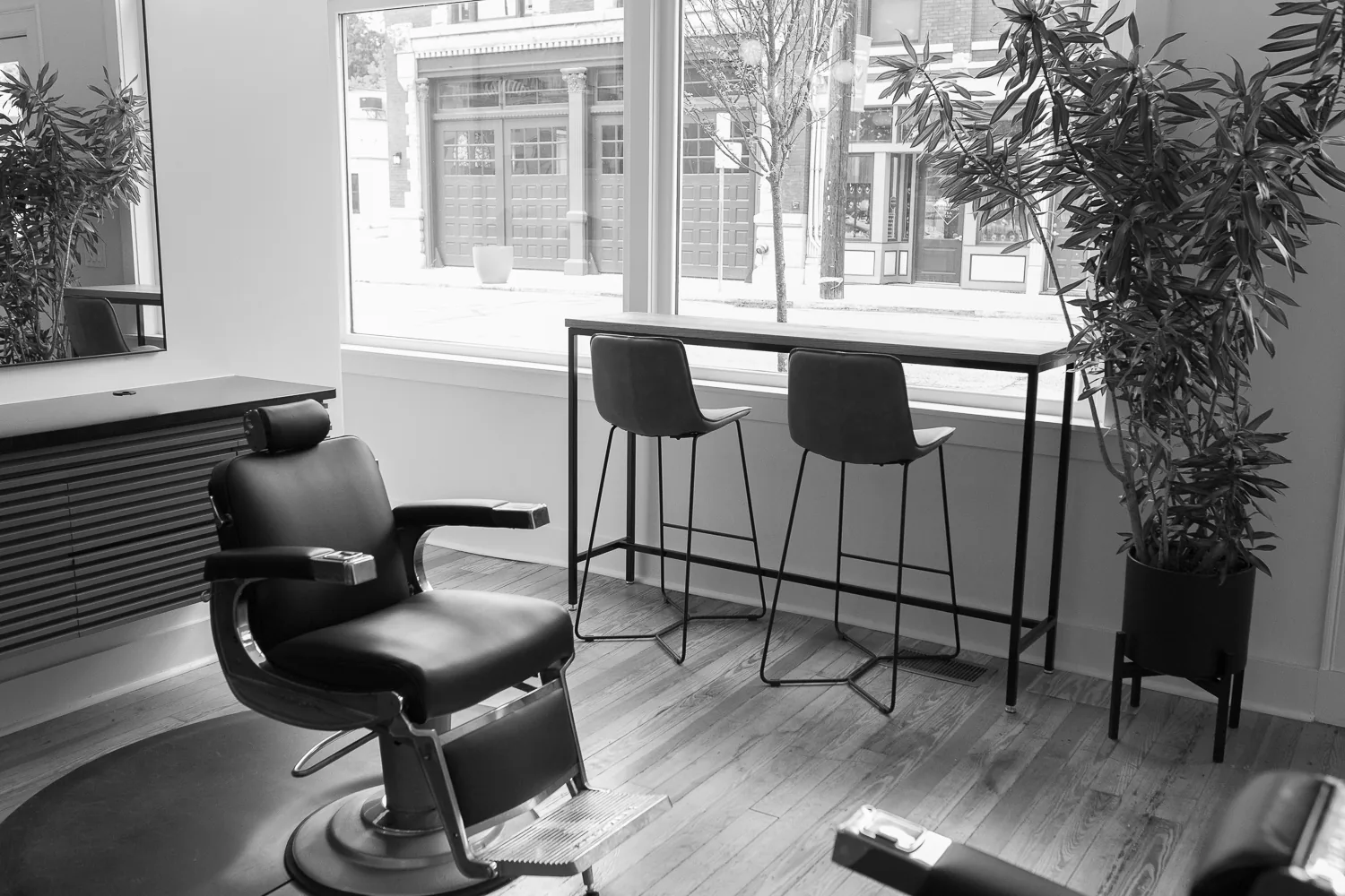 A barber chair beside a window at Cutman Barbershop's East Price Hill location